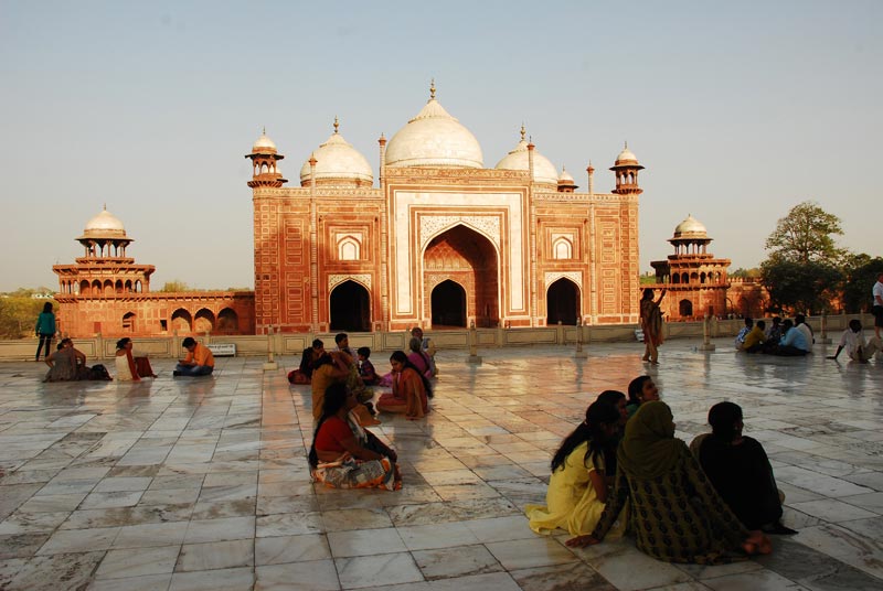 People sitting on floor of Taj Mahal