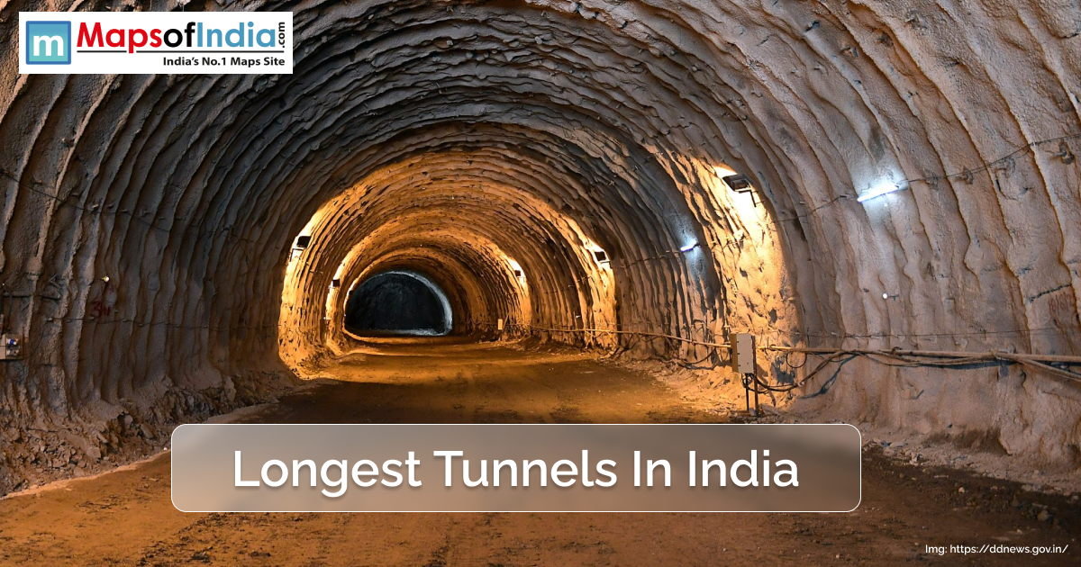 A view inside a large, illuminated tunnel in India, showcasing rough rock walls and ceiling with construction lights, representing one of the country's longest tunnels.