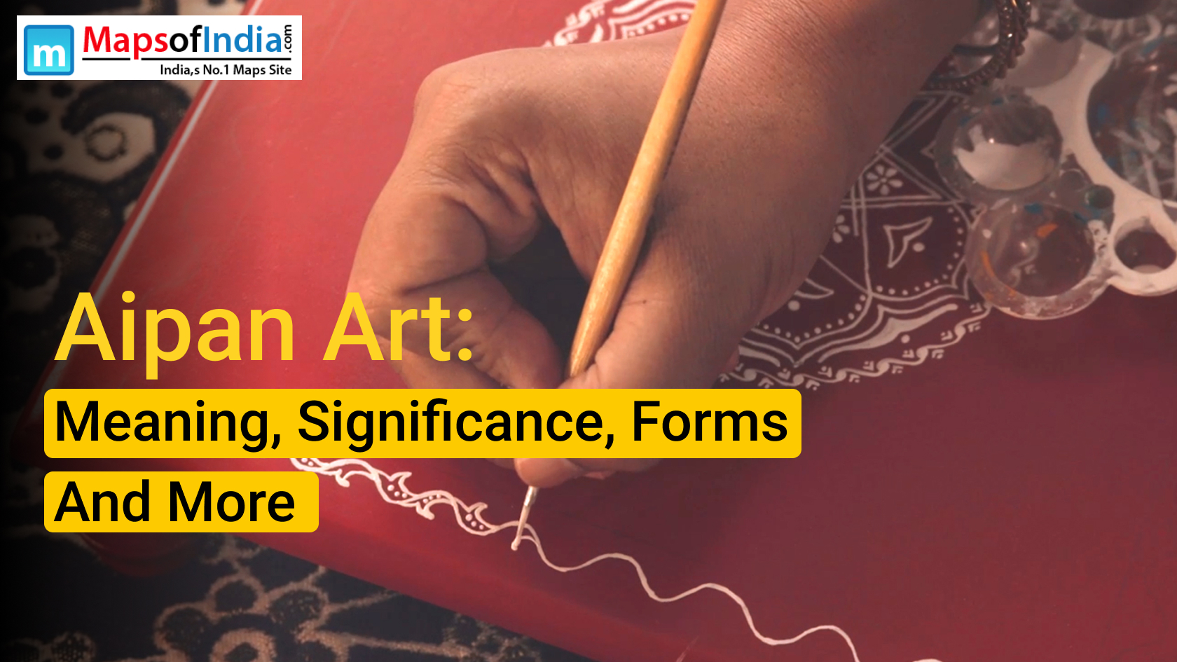 Traditional Aipan art with intricate white patterns on a red background, depicting floral and geometric designs.