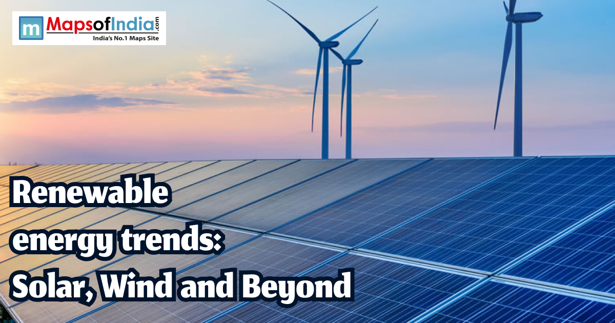 Solar panels and wind turbines at sunset representing renewable energy trends in India.