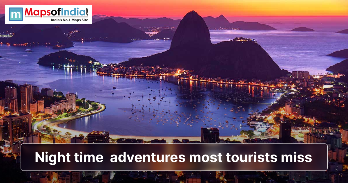 A vibrant coastal city at dusk with glowing lights, mountains, and a calm bay, illustrating night-time adventures most tourists miss.