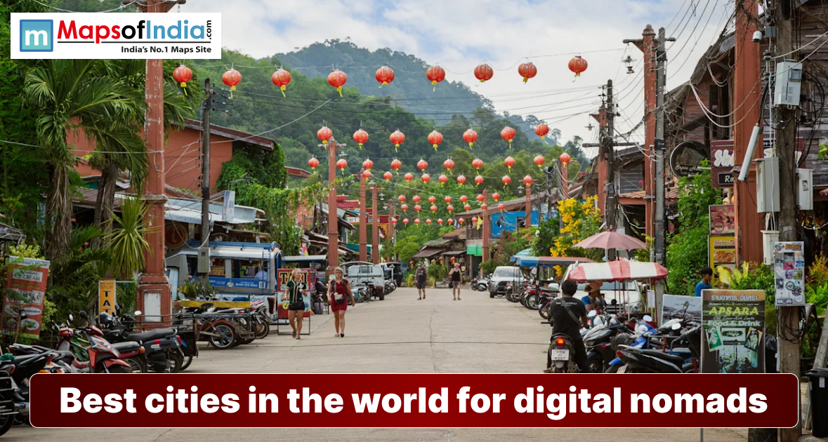 A vibrant street in a tropical town decorated with hanging red lanterns, featuring a banner that reads, "Best cities in the world for digital nomads."