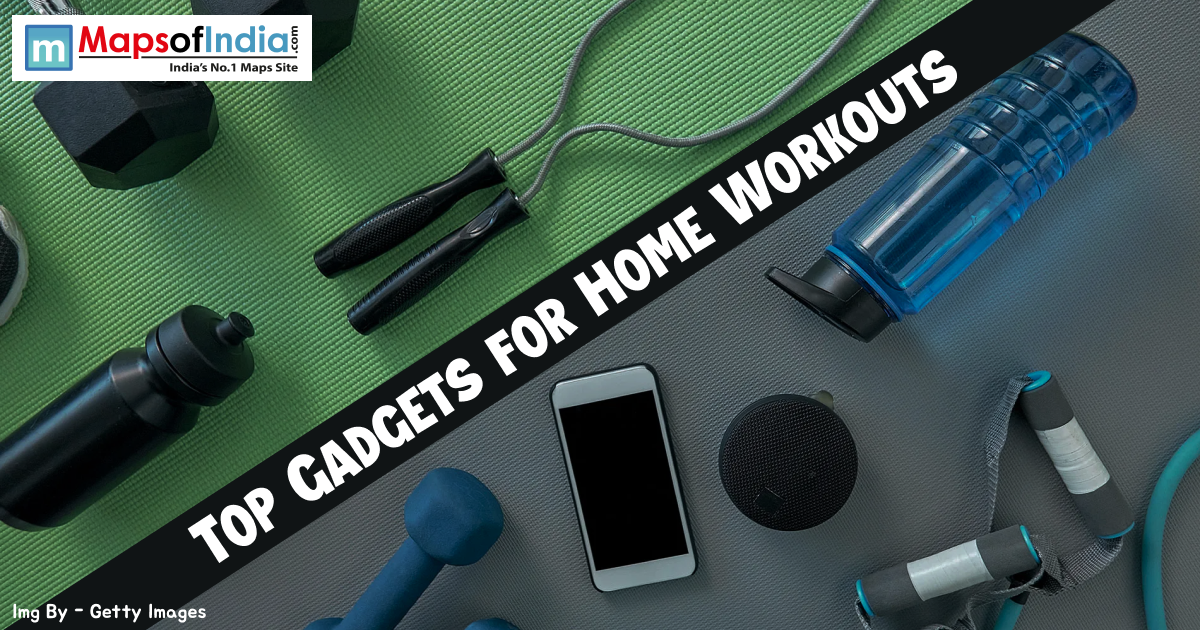 Top-down view of fitness equipment including dumbbells, a jump rope, resistance bands, a smartphone, and water bottles on a green and grey gym mat with the text "TOP GADGETS FOR HOME WORKOUTS."