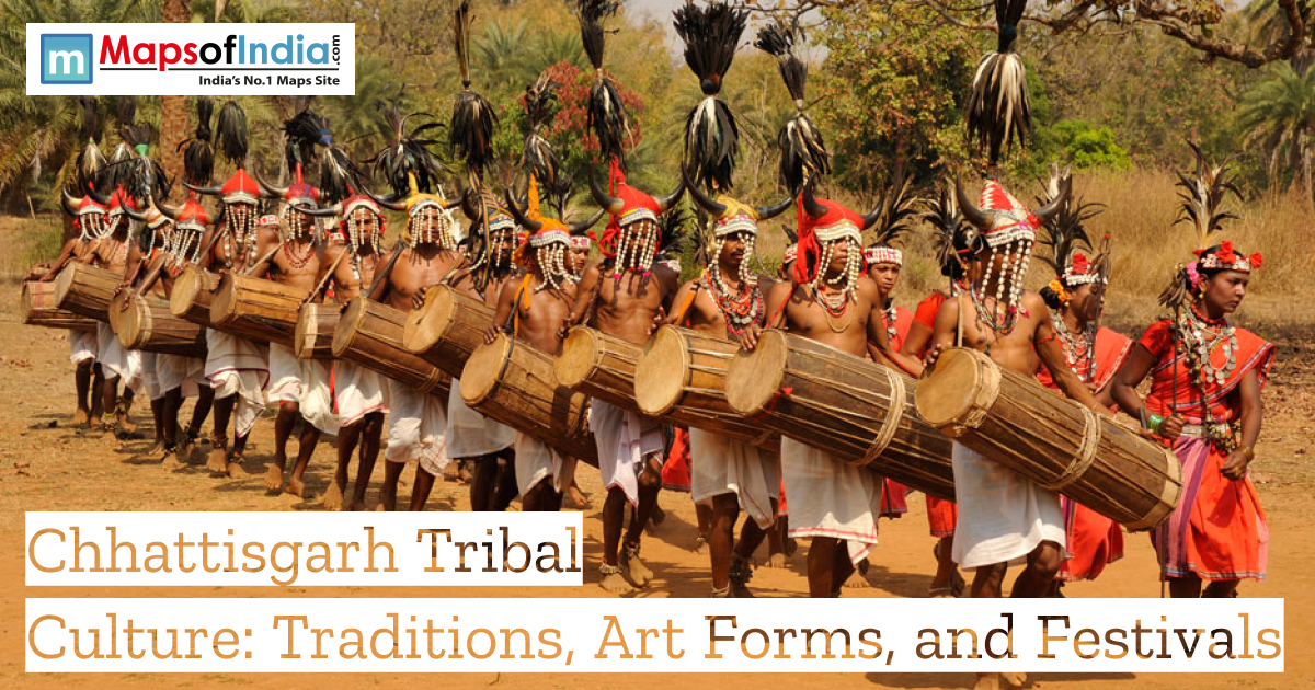 Tribal men in traditional attire performing a cultural dance with large drums during a festival procession in Chhattisgarh, wearing ornate headgear and bead jewelry, with banner text reading “Chhattisgarh Tribal Culture: Traditions, Art Forms, and Festivals.”