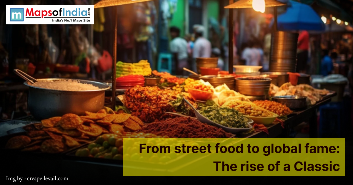 Colorful Indian street food stall at night displaying fried snacks, chutneys, spices, and fresh ingredients under warm lights, with a banner reading “From street food to global fame: The rise of a Classic."