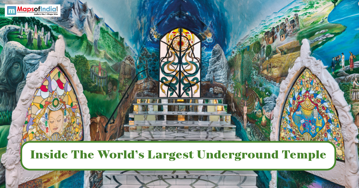 Colorful interior of a large underground temple featuring intricate murals, stained-glass artwork, and a grand central altar.